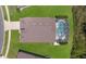 Drone's eye view capturing roof, pool, driveway, and surrounding lush green lawn at 2655 Star Lake View Dr, Kissimmee, FL 34747