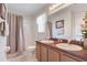 Bright bathroom features a double vanity, framed mirror, and shower at 2655 Star Lake View Dr, Kissimmee, FL 34747