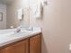 Half bathroom with wooden cabinets, mirror, sink and neutral walls at 2655 Star Lake View Dr, Kissimmee, FL 34747
