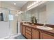 Bathroom boasts double sinks, wood cabinets, and a glass-enclosed shower at 2655 Star Lake View Dr, Kissimmee, FL 34747