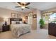 Comfortable bedroom with ceiling fan, window view, and soft decor at 2655 Star Lake View Dr, Kissimmee, FL 34747