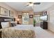 Comfortable bedroom boasts a ceiling fan, a window view, and soft decor at 2655 Star Lake View Dr, Kissimmee, FL 34747
