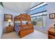 Bright bedroom featuring a wooden bunk bed and a window view of the neighborhood at 2655 Star Lake View Dr, Kissimmee, FL 34747