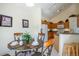 Dining area with views into the kitchen which features wood cabinetry and modern appliances at 2655 Star Lake View Dr, Kissimmee, FL 34747