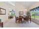 Dining area with seating for six, view to the living room, and plenty of natural light from a nearby window at 2655 Star Lake View Dr, Kissimmee, FL 34747