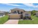 Inviting two-story home with manicured front lawn and charming architectural details at 2655 Star Lake View Dr, Kissimmee, FL 34747
