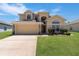 Charming two-story home featuring a well-maintained lawn and a spacious two-car garage at 2655 Star Lake View Dr, Kissimmee, FL 34747