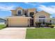 Beautiful two-story home with a well-kept lawn and attached two-car garage at 2655 Star Lake View Dr, Kissimmee, FL 34747