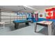 Fun game room featuring a pool table, air hockey, and international flags at 2655 Star Lake View Dr, Kissimmee, FL 34747