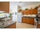 Bright kitchen featuring wood cabinets, granite countertops, and modern appliances at 2655 Star Lake View Dr, Kissimmee, FL 34747
