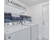 Well-equipped laundry room with a washer, dryer, and ample shelving at 2655 Star Lake View Dr, Kissimmee, FL 34747