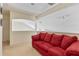 Upstairs living room with a red sofa, perfect for relaxation and entertainment at 2655 Star Lake View Dr, Kissimmee, FL 34747