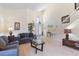 Bright living room featuring a high ceiling, neutral carpet, and staircase leading to the second floor at 2655 Star Lake View Dr, Kissimmee, FL 34747