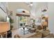 Open living area with a high ceiling, sliding doors to lanai, and easy access to the kitchen at 2655 Star Lake View Dr, Kissimmee, FL 34747