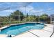 Sparkling screened-in pool with attached spa and lush landscaping at 2655 Star Lake View Dr, Kissimmee, FL 34747