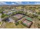 Aerial view of community tennis and shuffleboard courts with surrounding homes at 26807 Bull Run, Leesburg, FL 34748