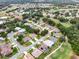 Residential neighborhood with lush green landscaping, winding roads, and a golf course in the background at 26807 Bull Run, Leesburg, FL 34748