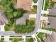 Aerial view of a home situated on a well maintained street surrounded by mature trees and greenery at 26807 Bull Run, Leesburg, FL 34748