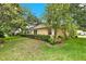 Well-maintained backyard featuring manicured hedges and mature shade trees at 26807 Bull Run, Leesburg, FL 34748