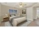 Cozy bedroom with neutral decor, ceiling fan, and access to ensuite bathroom at 26807 Bull Run, Leesburg, FL 34748