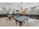 Recreation room with billiard tables, pendant lighting, and comfortable seating, ideal for entertainment at 26807 Bull Run, Leesburg, FL 34748