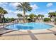 Inviting community pool featuring a spacious sun deck, lounge chairs, and a clear blue swimming area at 26807 Bull Run, Leesburg, FL 34748