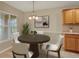 Dining area with a decorative chandelier, a round dining table, and a large window at 26807 Bull Run, Leesburg, FL 34748