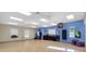 Spacious community fitness center featuring exercise equipment, hardwood floors, and ample natural light at 26807 Bull Run, Leesburg, FL 34748