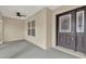 Inviting front porch with ceiling fan leading to an elegant front door, offering a welcoming entrance at 26807 Bull Run, Leesburg, FL 34748
