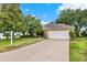 Charming single-story home with a well-manicured lawn, mature trees, and a two-car garage, offering curb appeal at 26807 Bull Run, Leesburg, FL 34748