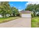 Charming home with a lush green lawn, mature trees, a two-car garage, and a welcoming entrance at 26807 Bull Run, Leesburg, FL 34748