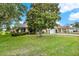Beautiful home featuring mature trees, a well-kept lawn, and attractive landscaping at 26807 Bull Run, Leesburg, FL 34748
