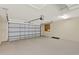Clean two-car garage with an insulated garage door and smooth concrete floor at 26807 Bull Run, Leesburg, FL 34748