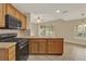Kitchen with wood cabinets, breakfast bar, and black appliances, an ideal place to enjoy Gathering time at 26807 Bull Run, Leesburg, FL 34748