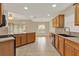 Kitchen with wood cabinets, bar seating, and stainless appliances, offering a great space for cooking at 26807 Bull Run, Leesburg, FL 34748