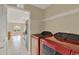 Laundry room showcasing modern appliances and a storage shelf, with a view to the kitchen at 26807 Bull Run, Leesburg, FL 34748