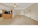 Spacious living room with tiled floors, ceiling fan, and open access to the kitchen area at 26807 Bull Run, Leesburg, FL 34748