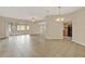 Bright living room featuring tile floors, ceiling fan, and sliding glass doors to the patio at 26807 Bull Run, Leesburg, FL 34748