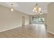 Open living area with tile floors, ceiling fan, and sliding glass doors to the outside at 26807 Bull Run, Leesburg, FL 34748