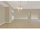 Open living space with tile flooring, neutral walls, and modern lighting creating an inviting atmosphere at 26807 Bull Run, Leesburg, FL 34748