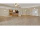 Bright, open-concept living space with tile flooring, neutral paint, and a view into the kitchen area at 26807 Bull Run, Leesburg, FL 34748