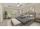 Bedroom with a tray ceiling, ceiling fan, neutral walls, large windows, and comfortable furniture at 26807 Bull Run, Leesburg, FL 34748