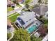 An aerial view shows the home with its enclosed pool and mature landscaping at 2712 Rolling Broak Dr, Orlando, FL 32837
