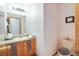 Cozy bathroom featuring a single sink vanity and a matching toilet with neutral decor at 2712 Rolling Broak Dr, Orlando, FL 32837