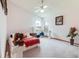Spacious bedroom with a red plaid blanket, ceiling fan, and natural light from the windows at 2712 Rolling Broak Dr, Orlando, FL 32837