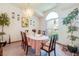 Dining room with chandelier, carpeted floor, large window and pink table setting at 2712 Rolling Broak Dr, Orlando, FL 32837