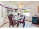 Elegant dining area with chandelier, bay windows, and modern table set at 2712 Rolling Broak Dr, Orlando, FL 32837