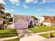 Charming two-story home features a well-manicured lawn and attached two-car garage at 2712 Rolling Broak Dr, Orlando, FL 32837