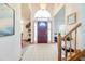 Bright foyer with tile flooring, a high ceiling and arched window above the front door at 2712 Rolling Broak Dr, Orlando, FL 32837