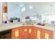 Bright kitchen with light wood cabinets, tile floors, and an open layout at 2712 Rolling Broak Dr, Orlando, FL 32837